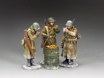 Image of 'Staying Warm'--three WWII American GI figures in overcoats standing around an oil drum brazier