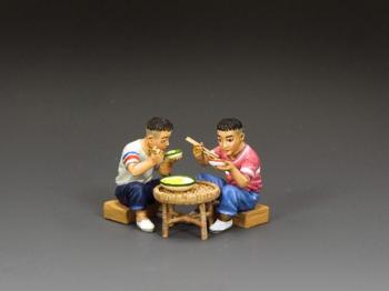 Image of Boys Sitting Eating--two seated 1960s-era figures and table