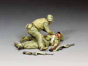 Image of "Wounded!"--two Vietnam-era figures and two weapons